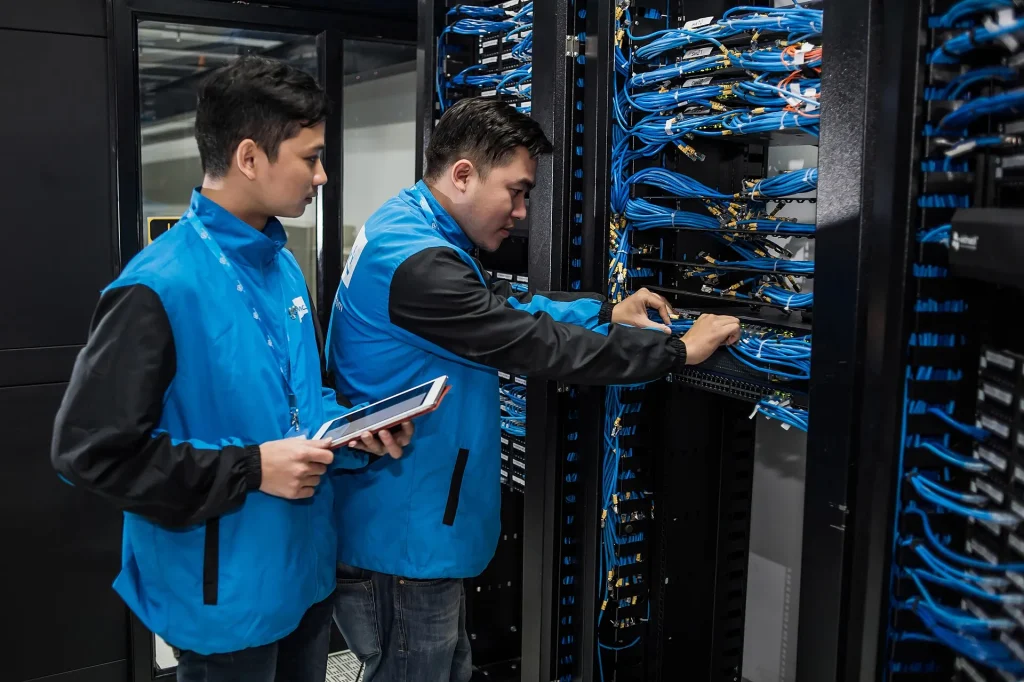 AI Features Are Becoming a Commodity, and Cloud Prices Show It Cooling towers above server halls inside an active data centre facility.