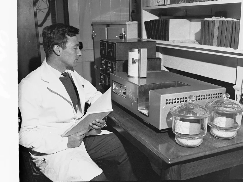 Inside the Workforce That Keeps Outbreak Tracking Running A laboratory scientist examining material as part of disease surveillance work.