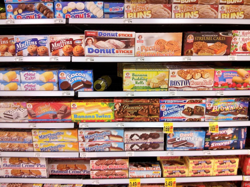 Nine in Ten Papers Questioning Ultra-Processed Food Definition Had Industry Ties, Study Finds Supermarket shelves with packaged foods and nutrition labels